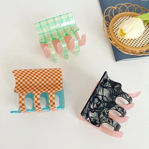 Three-piece set of acetate claw clips featuring green plaid, orange checkerboard and marble