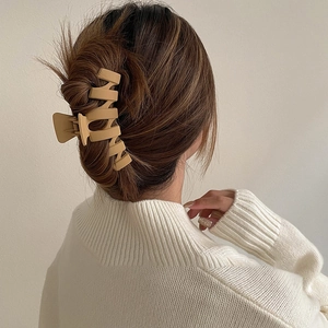 Matte ginger geometric hair claw clip shown on model for elegant updo hairstyling