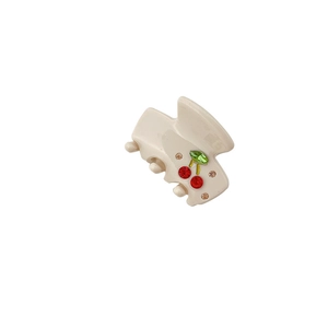 Minimalist acetate hair claw clip with crystal cherry motif on white background