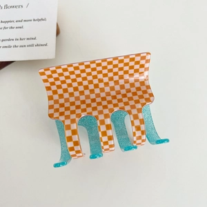 Orange and white checkered claw clip with blue glitter interior for hair styling
