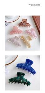 Close-up of large acetate hair claw clips with marble and tortoiseshell patterns