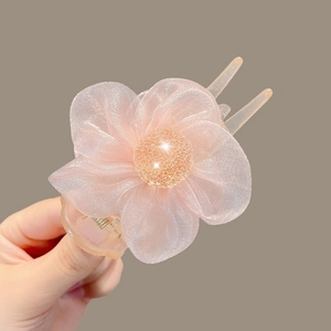 Detailed close-up of pink organza camellia flower hair claw clip with delicate resin base