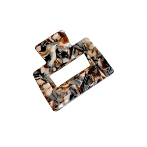 Small square acetate hair claw clip with vintage amber marble pattern for women