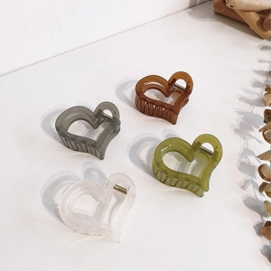 Set of four cute heart-shaped acrylic hair claws in amber white green and grey colors