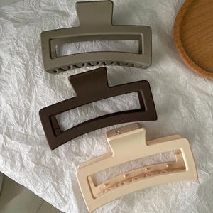 Three large matte rectangular hair claws in olive green, dark coffee, and beige colors