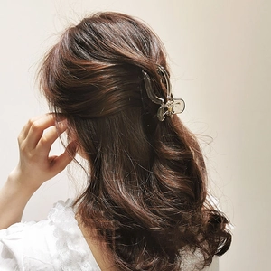 Smoky grey acrylic hair claw clip for bun styles shown on model hair from behind