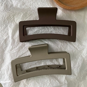 Flat lay of two matte large rectangular hair claw clips in coffee and khaki brown colors
