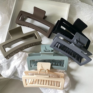 Close-up of six matte Morandi rectangular hair claw clips in a minimalist 13cm hollow design