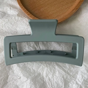 Close-up of 13cm matte sage green rectangular hair claw clip for thick hair