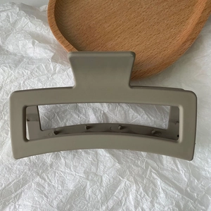 Detail view of a 13cm matte grey-brown rectangular hair claw clip with non-slip teeth