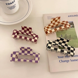 Set of four checkered acetate hair claws in black, brown, red, and purple patterns