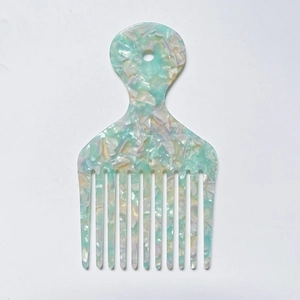 Macro detail of marble pattern acetate wide-tooth comb with handle hanging hole