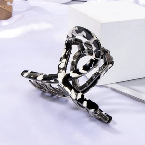Macro shot of large black and white marble acetate hair claw clip with strong alloy spring