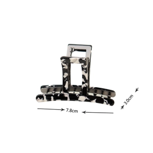 Detail view of black and white marble hair claw clip showing 7.8cm length and 3.0cm height