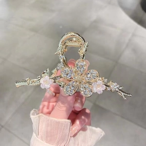 Eleganter goldener Blumen-Haarclip mit Strasssteinen und rosa Blumenzweig-Details