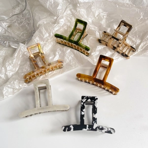 Detailed set of six acetate leopard print hair claws in various vintage marble patterns