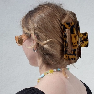 Vintage leopard tortoise shell acetate hair claw clip shown on a model side view