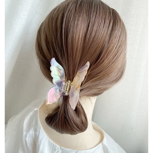 French vintage butterfly hair claw with iridescent holographic finish on blonde hair