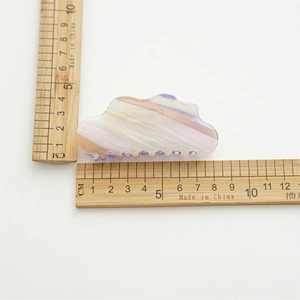 Cloud shaped acetate hair claw clip with pearlescent marble texture in purple and beige