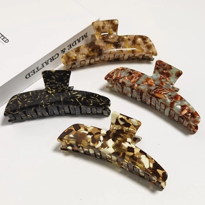Set of 4 acetate shark hair claws featuring tortoiseshell and marble patterns for women