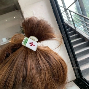 Creative Mahjong hair clip with red character design worn as a stylish side fringe accessory