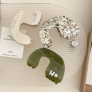 Three elegant U-shaped hair claws in ivory, floral, and green with H-letter rhinestone detail