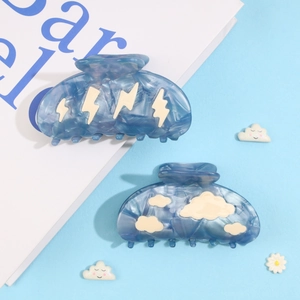 Cloud and lightning acetate hair claw clips with blue marble pattern on soft blue background