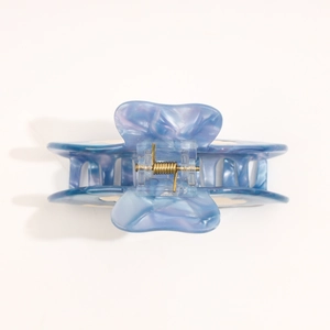 Detail view of acetate cloud-shaped claw clip with blue and purple marble texture