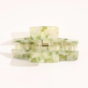 Detail view of large marbled green acetate hair claw clip with strong metal spring