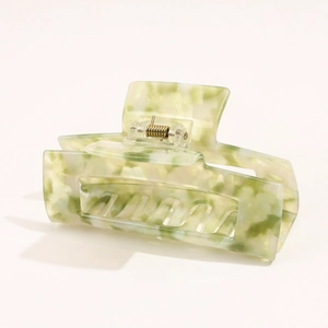Detail of green and white marble pattern acetate hair claw clip with rectangle hollow design
