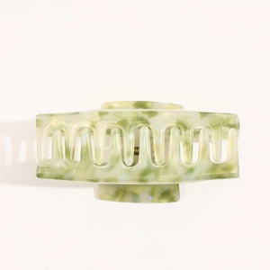 Detail of large marble green acetate hair claw clip showing the spring and tooth design