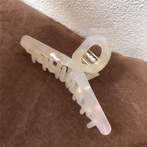 Large iridescent cream hair claw clip with pearlescent finish for thick hair styling