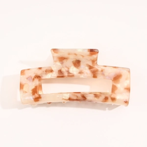 Detailed view of rectangle tortoiseshell claw clip with polished finish and metal spring