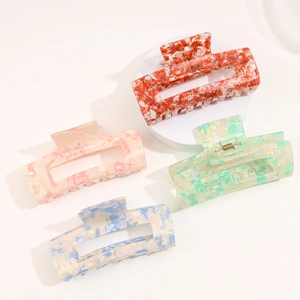 Set of four marbled acetate square hair claws in orange, pink, green, and blue colors