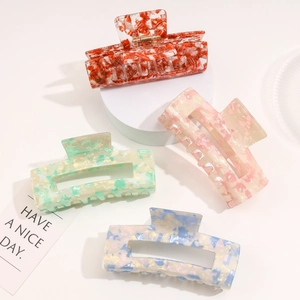 Detailed set of four colorful acetate hair claws with elegant marble patterns