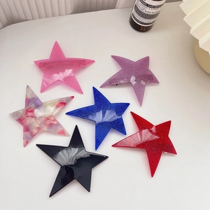 Detail view of six star-shaped glitter and marble patterned resin hair clips set