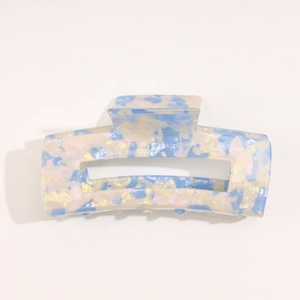 Macro detail of sky blue and white marbled acetate hair claw clip with cutout