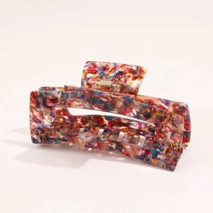Detailed close-up of marble pattern acetate hair claw clip with rectangular hollow design