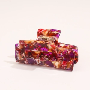 Detail of French vintage marble texture hair claw with sturdy gold metal spring clip