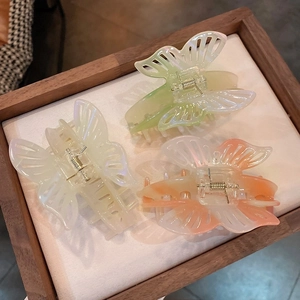 Elegant butterfly hair claws with pearlescent finish in cream green and pink shades