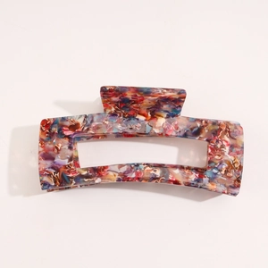 Detail of French vintage acetate claw clip with colorful floral marble texture finish