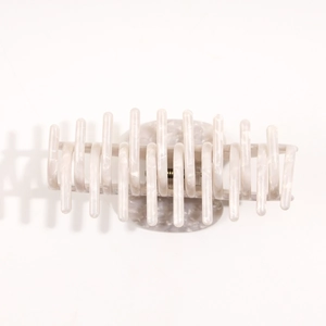 Close-up of cream marble acetic acid hair claw clip with strong metal spring
