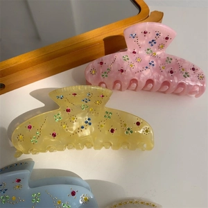 Elegant acetate flower hair claw clip with colorful rhinestones and marble texture