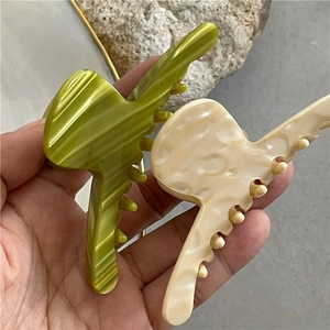 Minimalist acetate hair claw clips in green and cream white with elegant textures