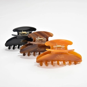 Three-piece set of large acetate hair claws in black, tortoiseshell, and amber tones