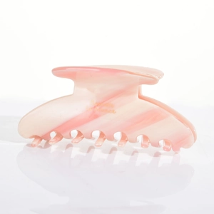 Close-up of pink marble pattern acetate hair claw clip with Barette la France text