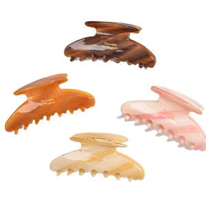 Large acetate hair claws in tortoise shell and marble patterns for thick hair styling
