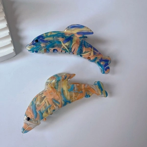 Chic dolphin-shaped hair claws made of marble-textured acetate for stylish updos