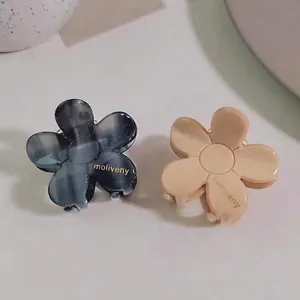 Elegant acetate camellia flower hair claws in marble grey and beige cream finishes