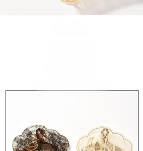 Close-up of French lace hair claw clips with gold moon and star patterns in black and beige